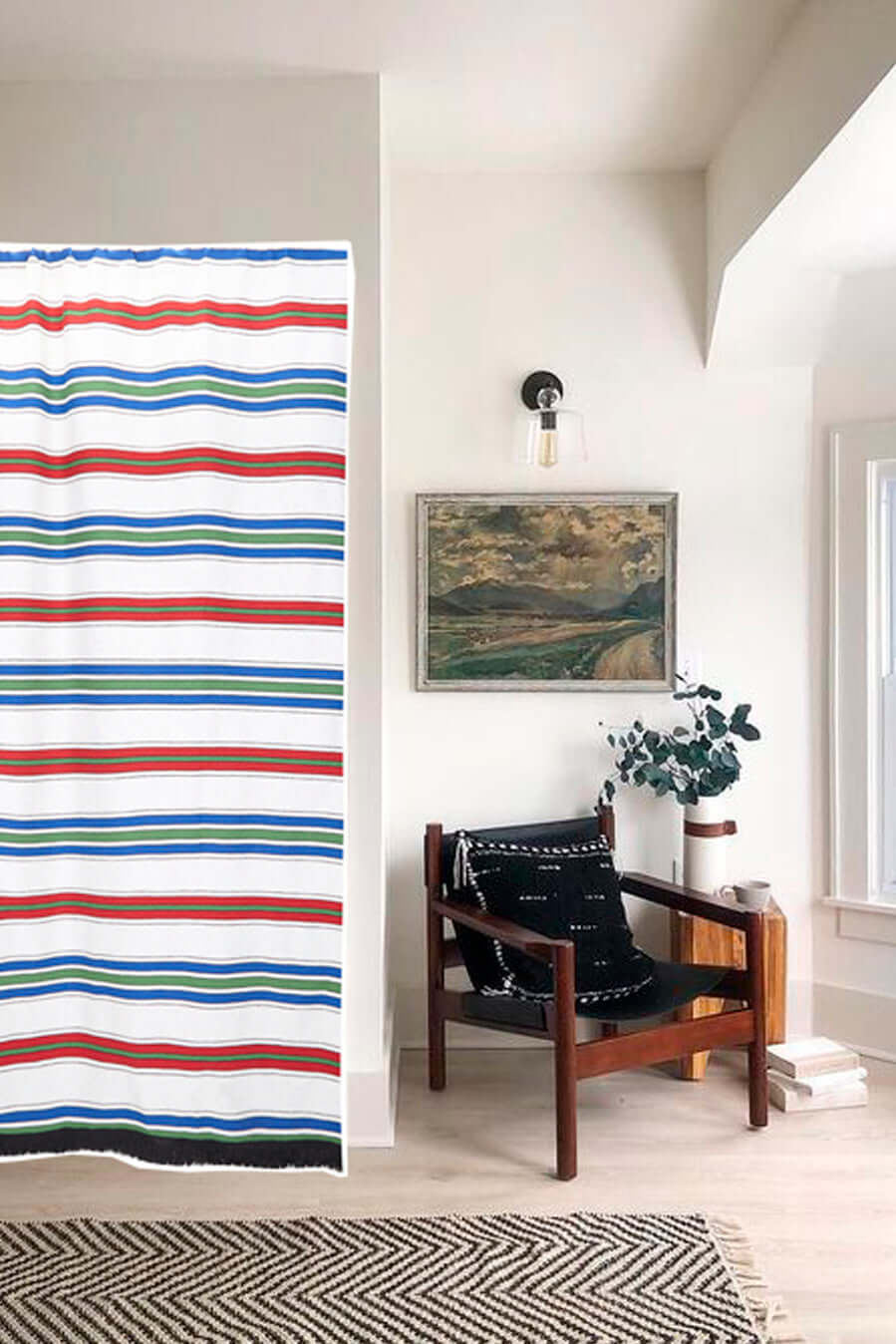 Cortina canario rayas multicolor decorando salón blanco con butaca madera y cuadro - cortina terraza estilo mediterráneo