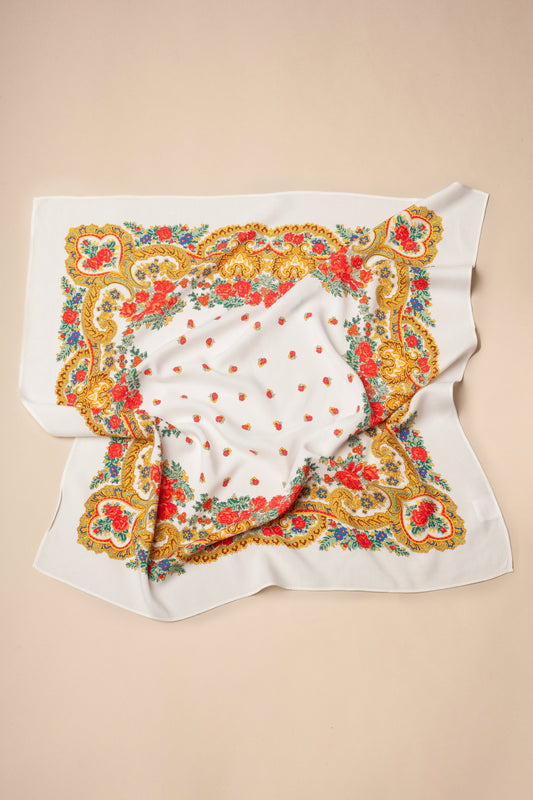 White square scarf featuring a colorful floral and gold chain pattern with scattered red rosebuds.