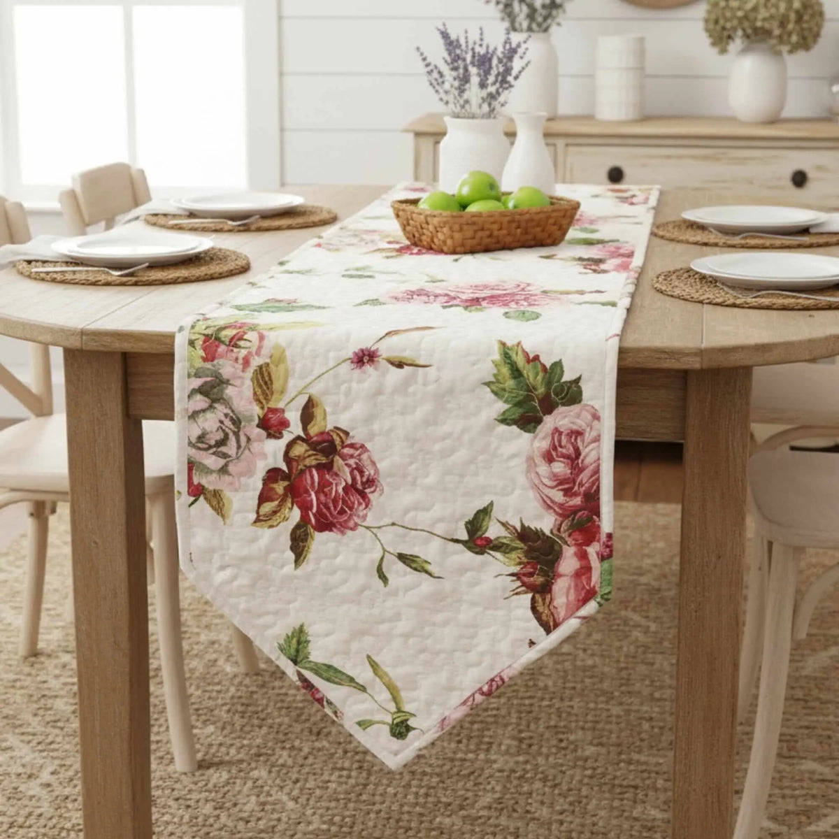 Quilted cream dining table runner featuring a romantic pink and red rose floral pattern with pointed ends.
