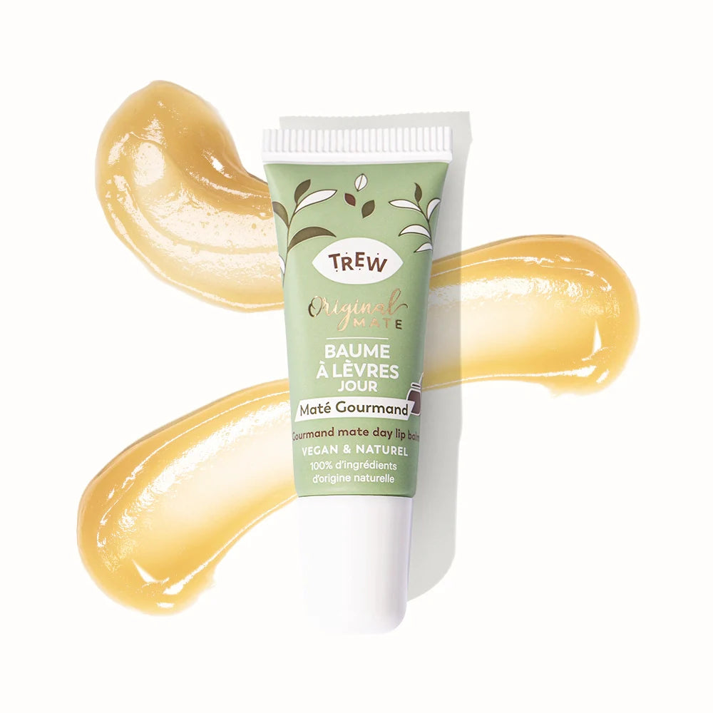Light green tube of Trew lip balm centered on a white background with two swatches of golden, glossy balm behind it.