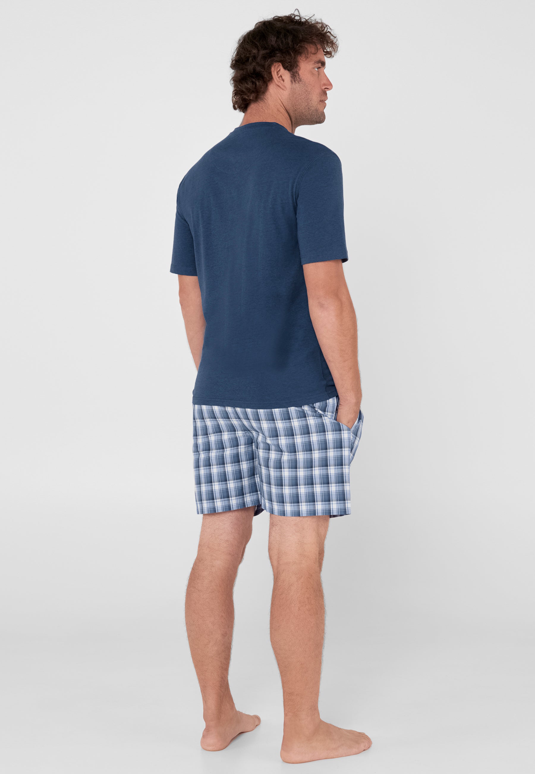 Conjunto de pijama para hombre: camiseta azul marino de algodón y pantalones cortos a cuadros en tonos azul y blanco.
