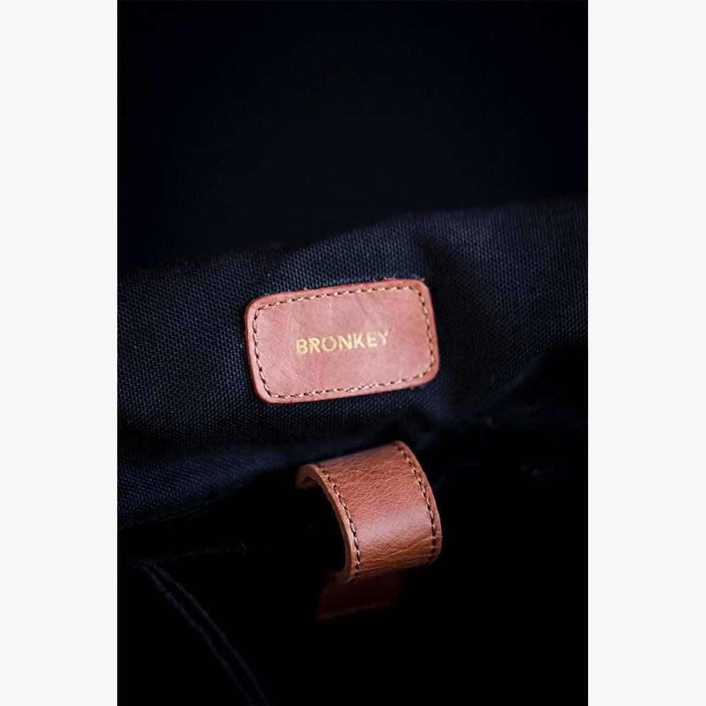 Close-up of the handmade waxed canvas camera bag's interior tag labeled 'BRONKEY'.