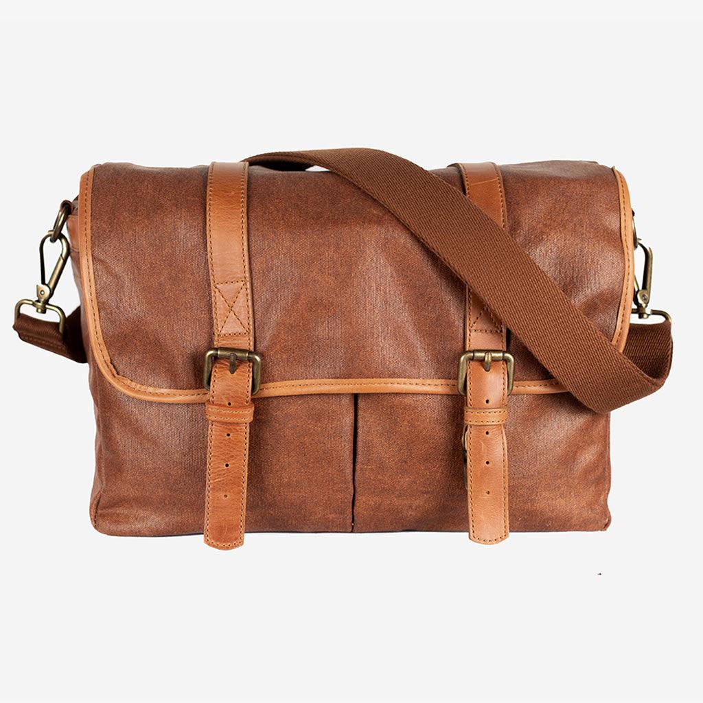 Handmade waxed canvas camera bag in brown leather with adjustable strap and buckle details.
