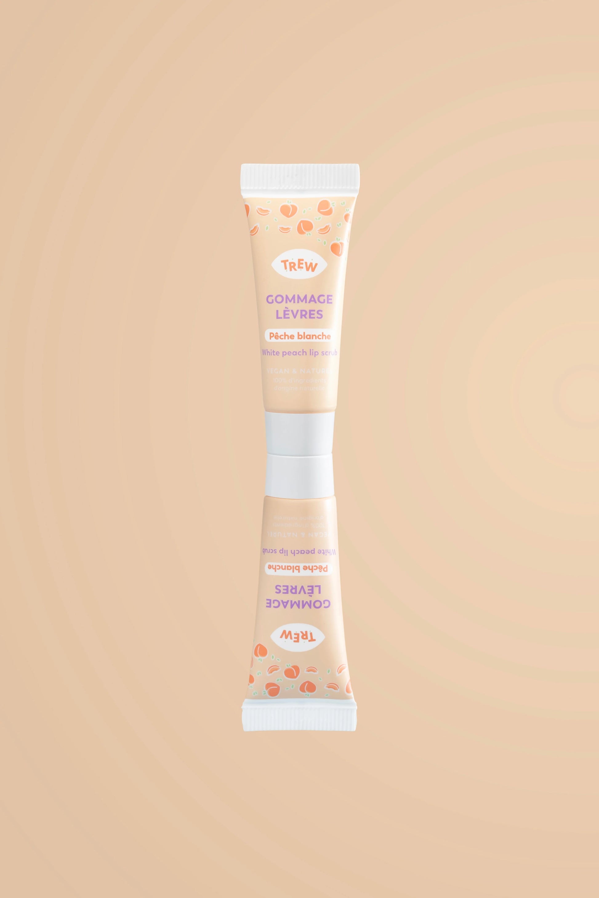 Tube de gommage lèvres Trew pêche blanche, fond beige, motifs pêches, inscription violette, design épuré et moderne.