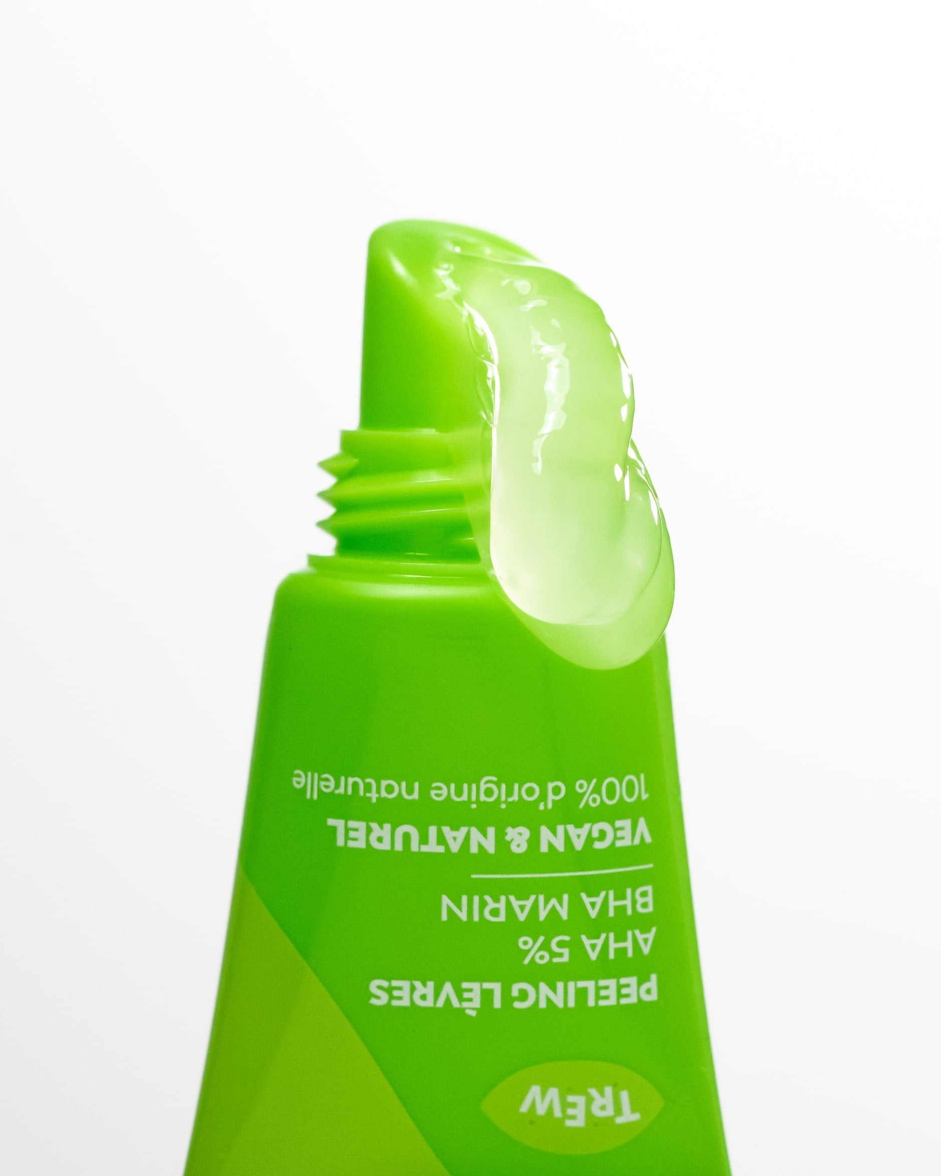 Bright green squeeze tube with a slanted applicator tip dispensing a clear, thick gel serum against a white background.