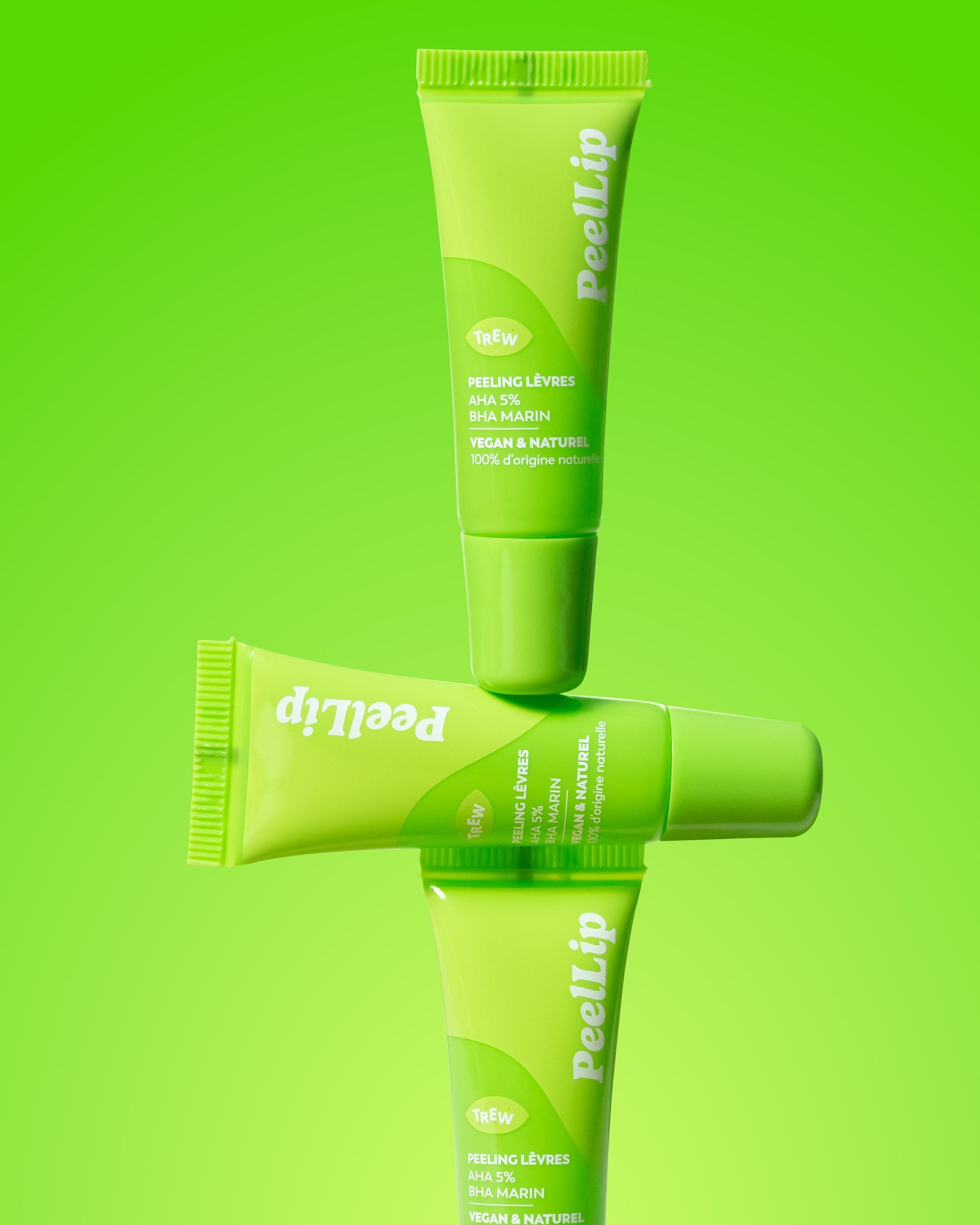 Three vibrant lime-green cosmetic tubes of PeelLip exfoliant stacked vertically against a matching neon green background.