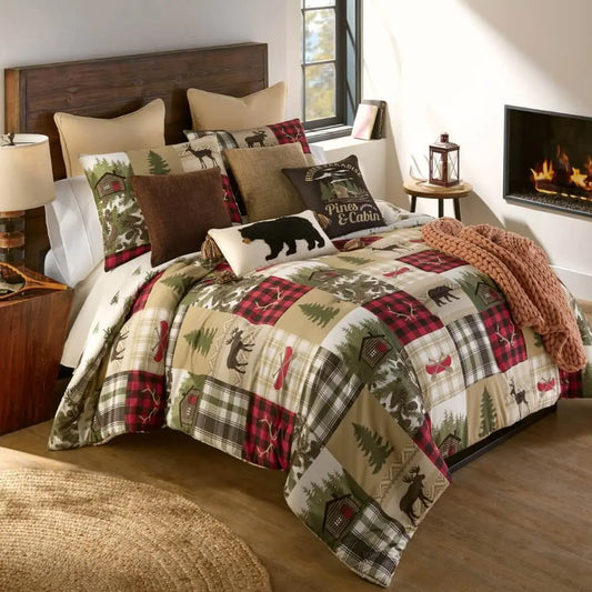 Rustic cabin comforter featuring a red and black buffalo plaid, pine tree, cabin, and wildlife patchwork pattern.