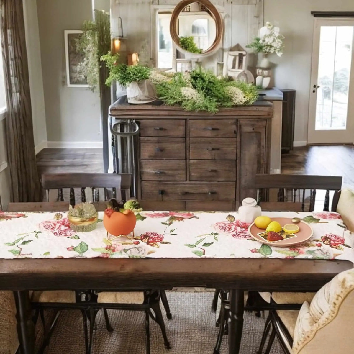 Quilted white dining table runner featuring a romantic pink and green rose floral print on a dark wooden table.