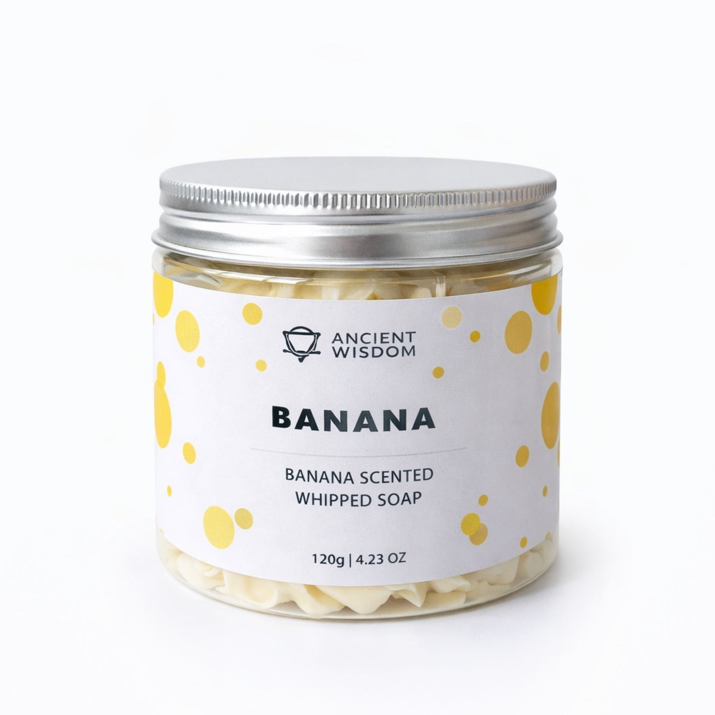 Jabón batido con aroma a plátano, 120g, en frasco de vidrio con tapa plateada y etiqueta blanca con puntos amarillos.