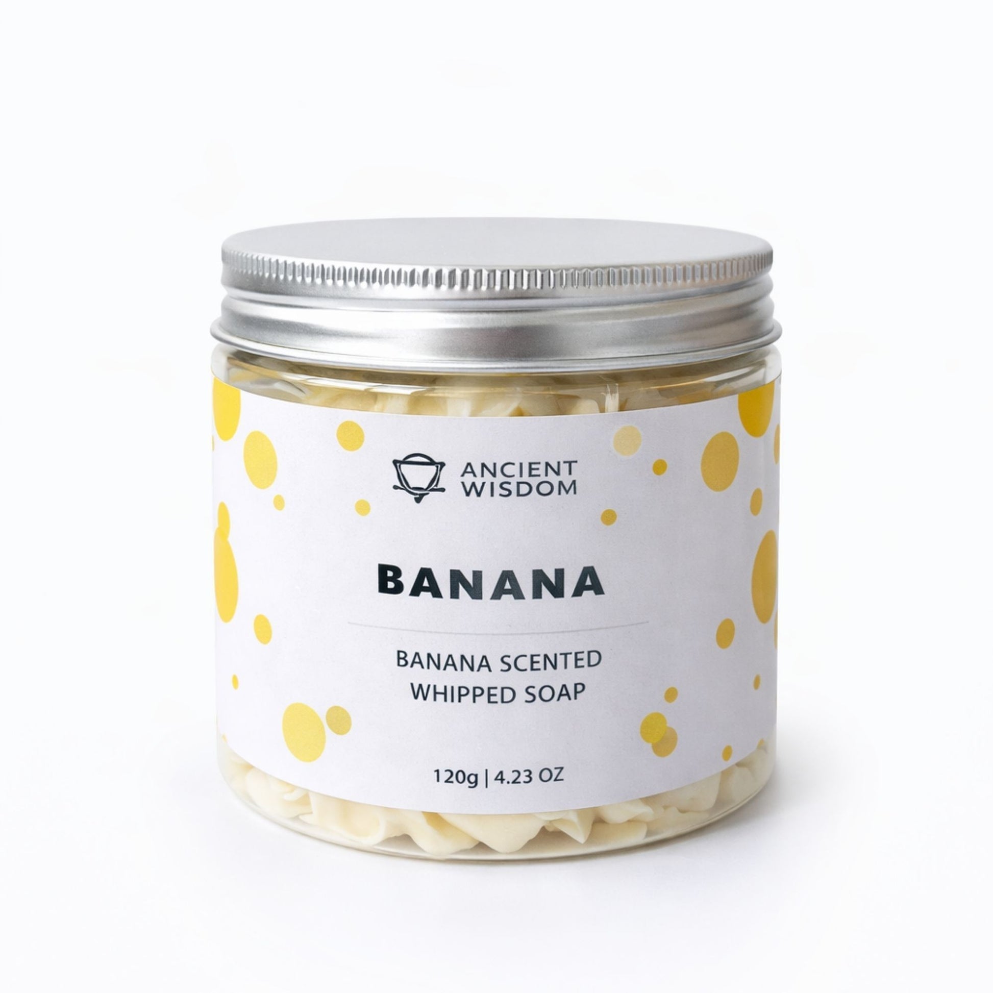 Jabón batido con aroma a plátano, 120g, en frasco de vidrio con tapa plateada y etiqueta blanca con puntos amarillos.