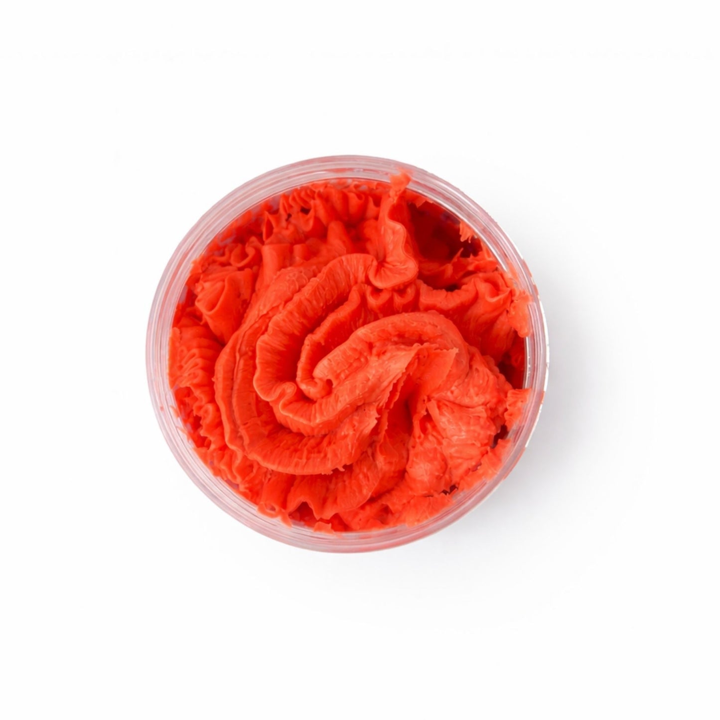 Crema de textura suave en color naranja vibrante, presentada en un frasco transparente. Ideal para cuidado de la piel.