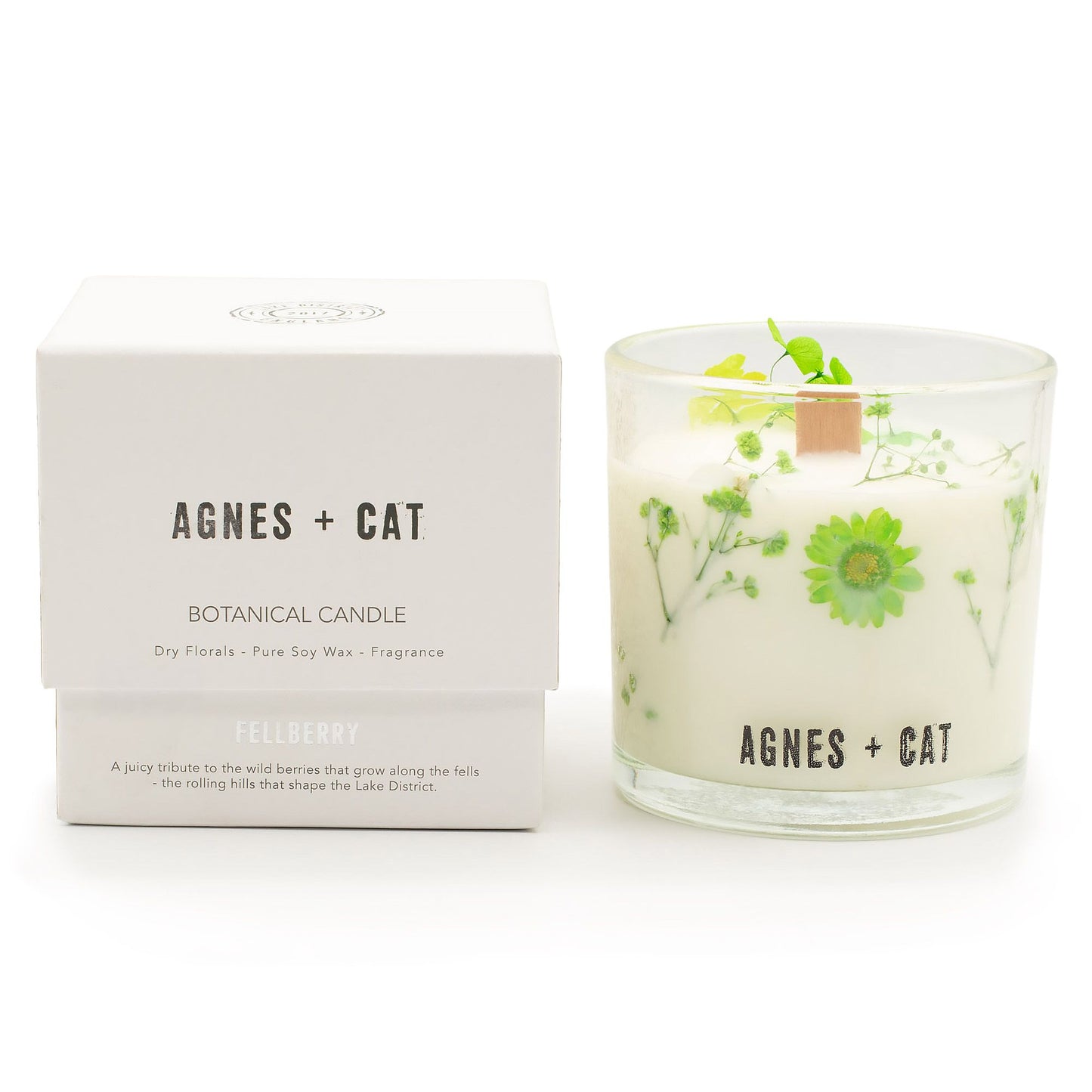 Vela botánica blanca con flores secas verdes, cera de soja pura y fragancia, envase de vidrio elegante.