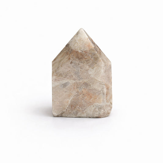 Piedra mineral en forma de casa, tonos beige y gris, superficie pulida, ideal para decoración y prácticas espirituales.