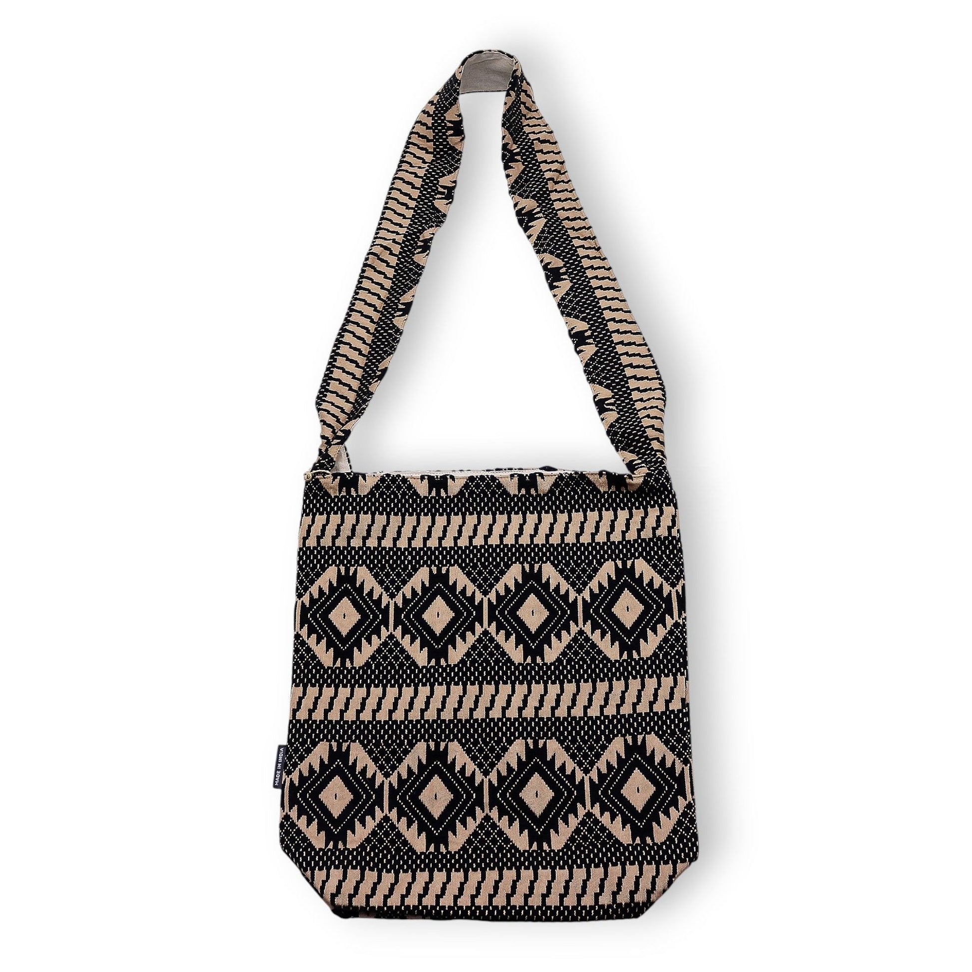 Bolso portátil de tela con diseño geométrico en negro y beige, asa larga y estilo bohemio.