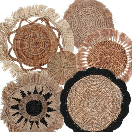 Surtido de alfombras redondas de yute y palma en tonos naturales, negro y beige, con detalles de flecos y trenzado.