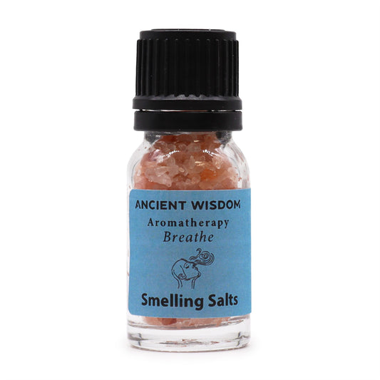 Frasco de vidrio con sales rosadas, tapón negro y etiqueta azul con la marca Ancient Wisdom y el nombre "Breathe".
