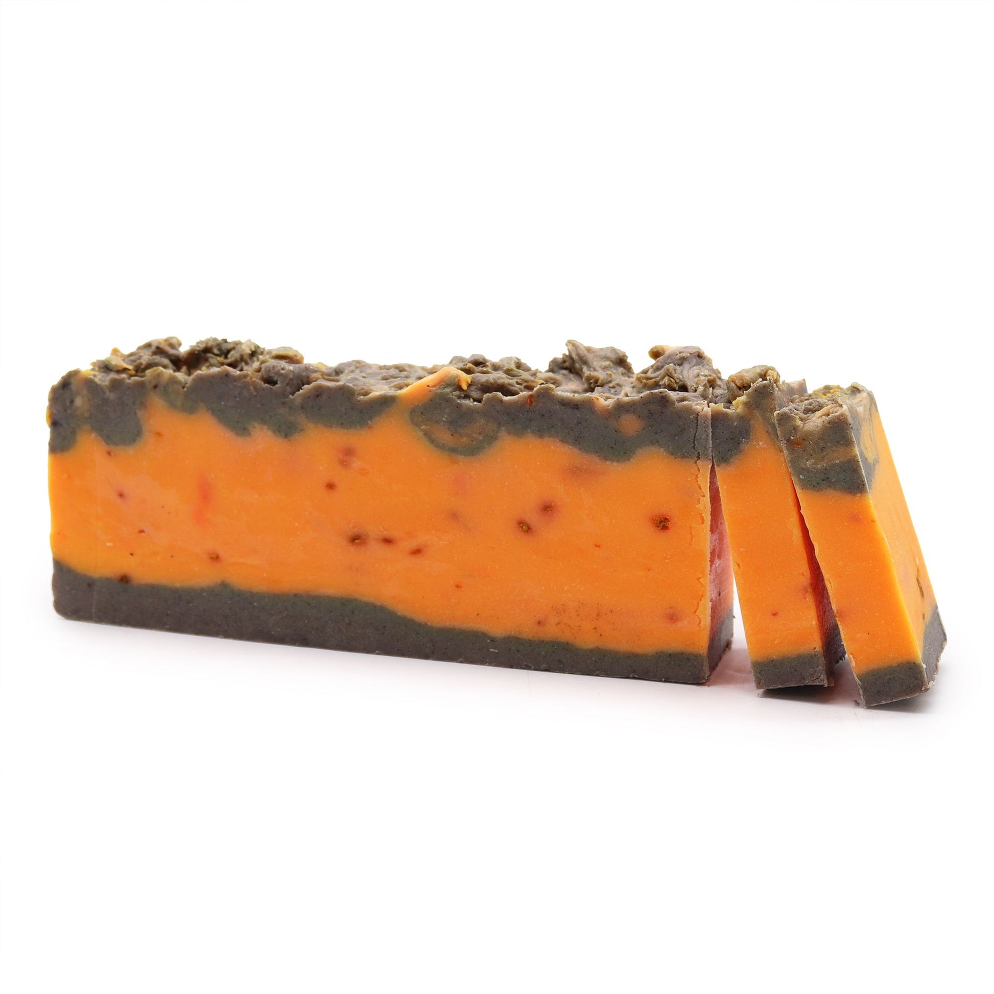 Barra de jabón artesanal Ancient Wisdom, bicolor naranja y marrón, textura rústica, aroma a canela y naranja.