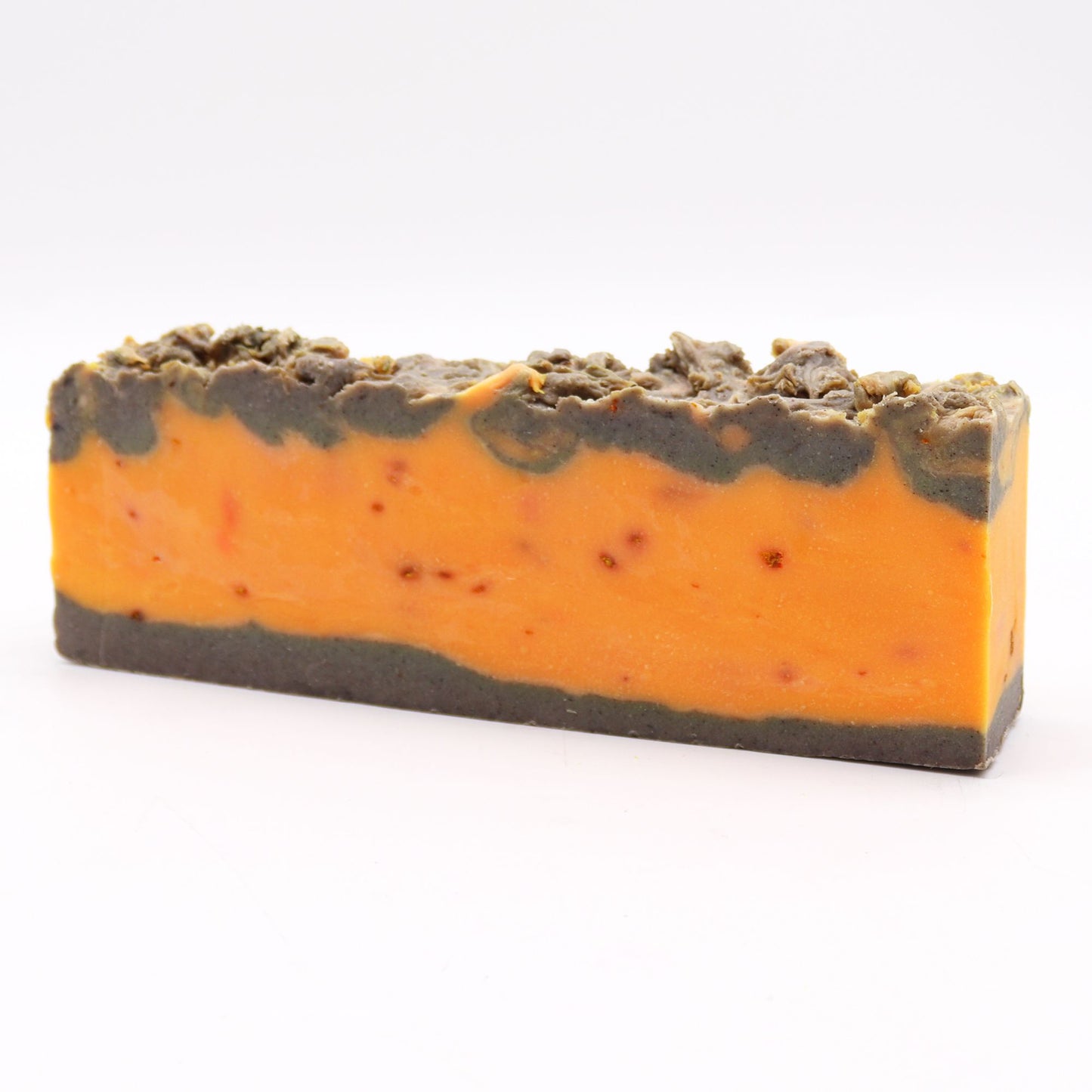 Barra de jabón artesanal Ancient Wisdom (1,25kg) en tonos naranja y gris, con textura rústica y acabado natural.