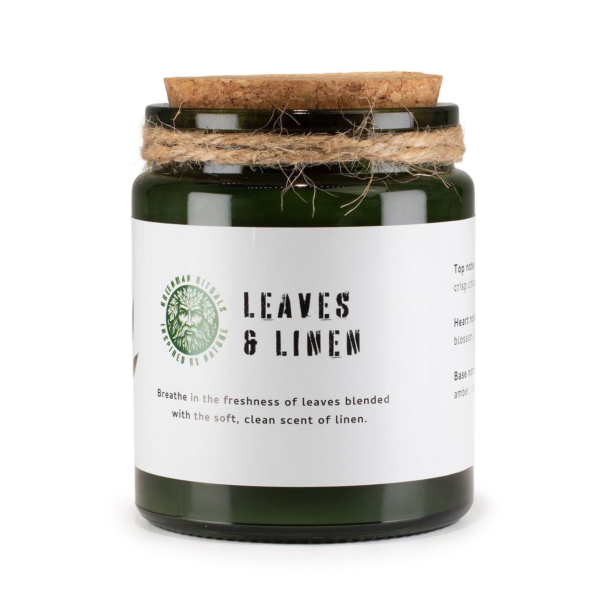 Vela verde en frasco de vidrio con tapa de corcho, aroma fresco a hojas y lino, decorativa y elegante.