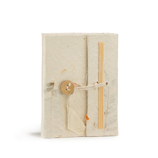 Cuaderno artesanal en papel reciclado, color blanco, con cierre de madera y cinta de bastidor en estilo rústico.