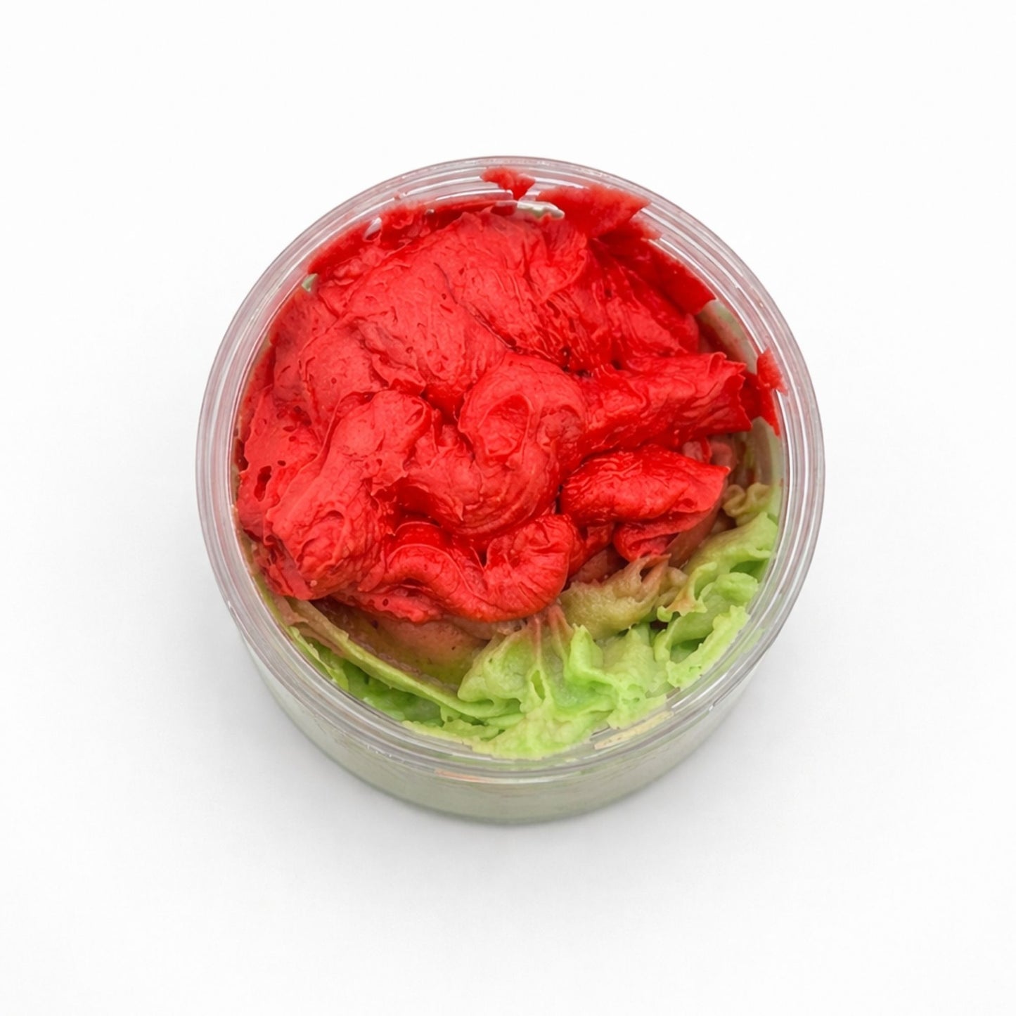 Masa para decorar pasteles en tonos rojo y verde, textura suave en envase transparente. Ideal para repostería creativa.