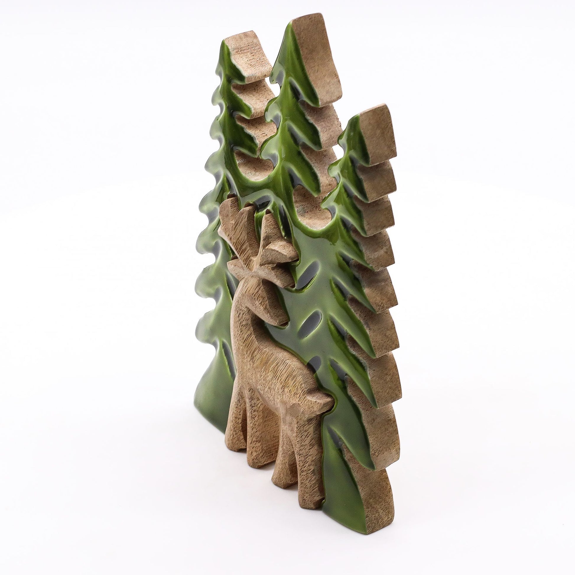 Escultura decorativa de ciervo en tonos verde y marrón, con árboles de fondo, estilo rústico y natural.
