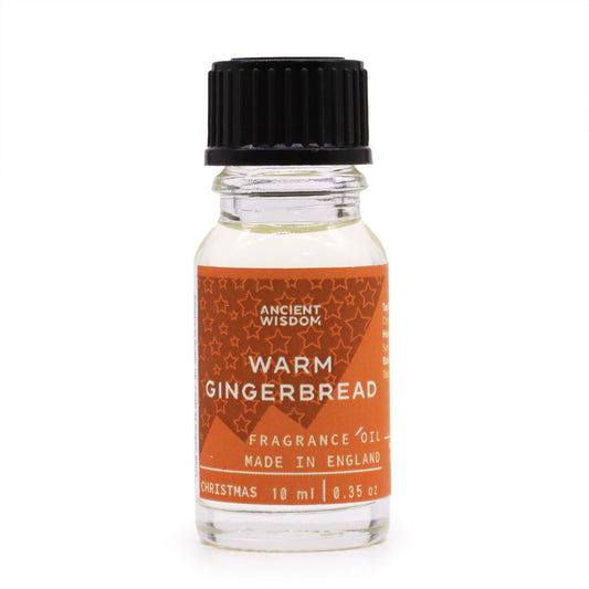 Frasco de vidrio transparente de 10 ml con aceite, tapón negro y etiqueta naranja con estrellas y texto en blanco.