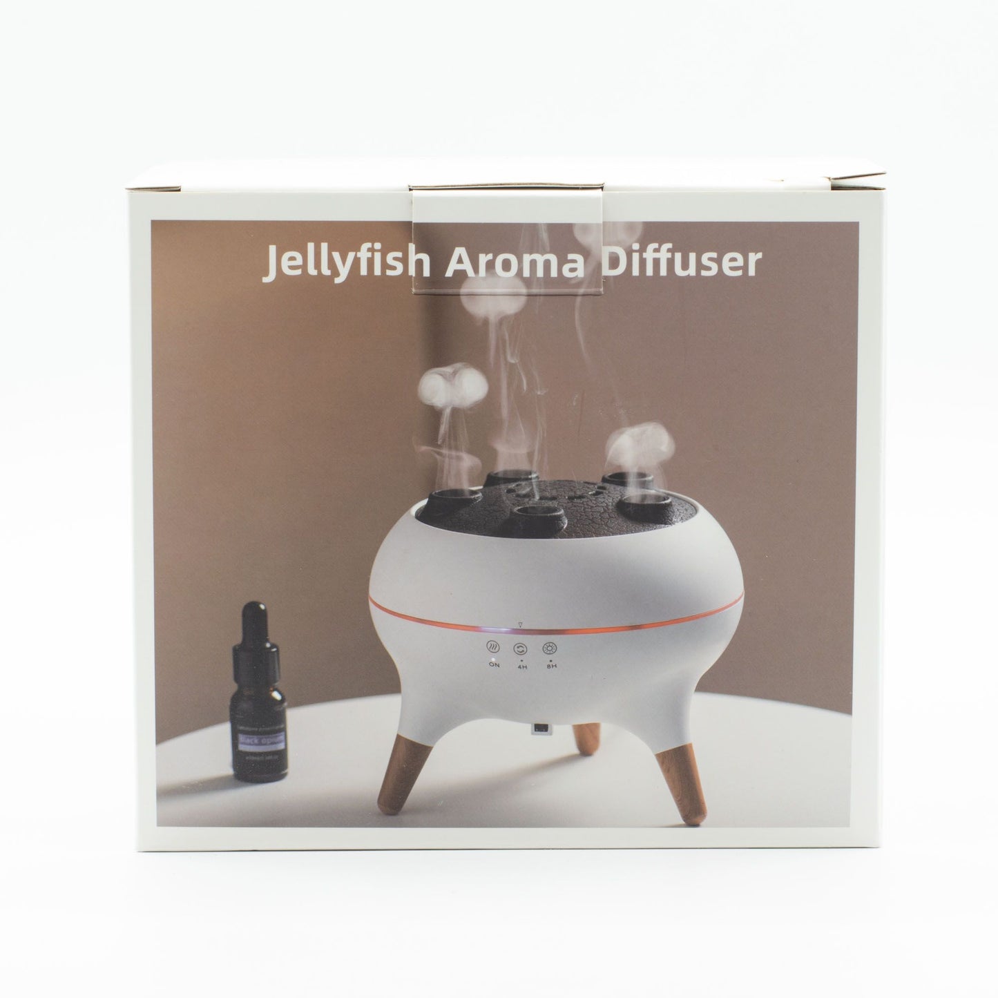 Difusor blanco con tres patas de madera emitiendo vapor en forma de medusa, junto a un frasco de aceite esencial.