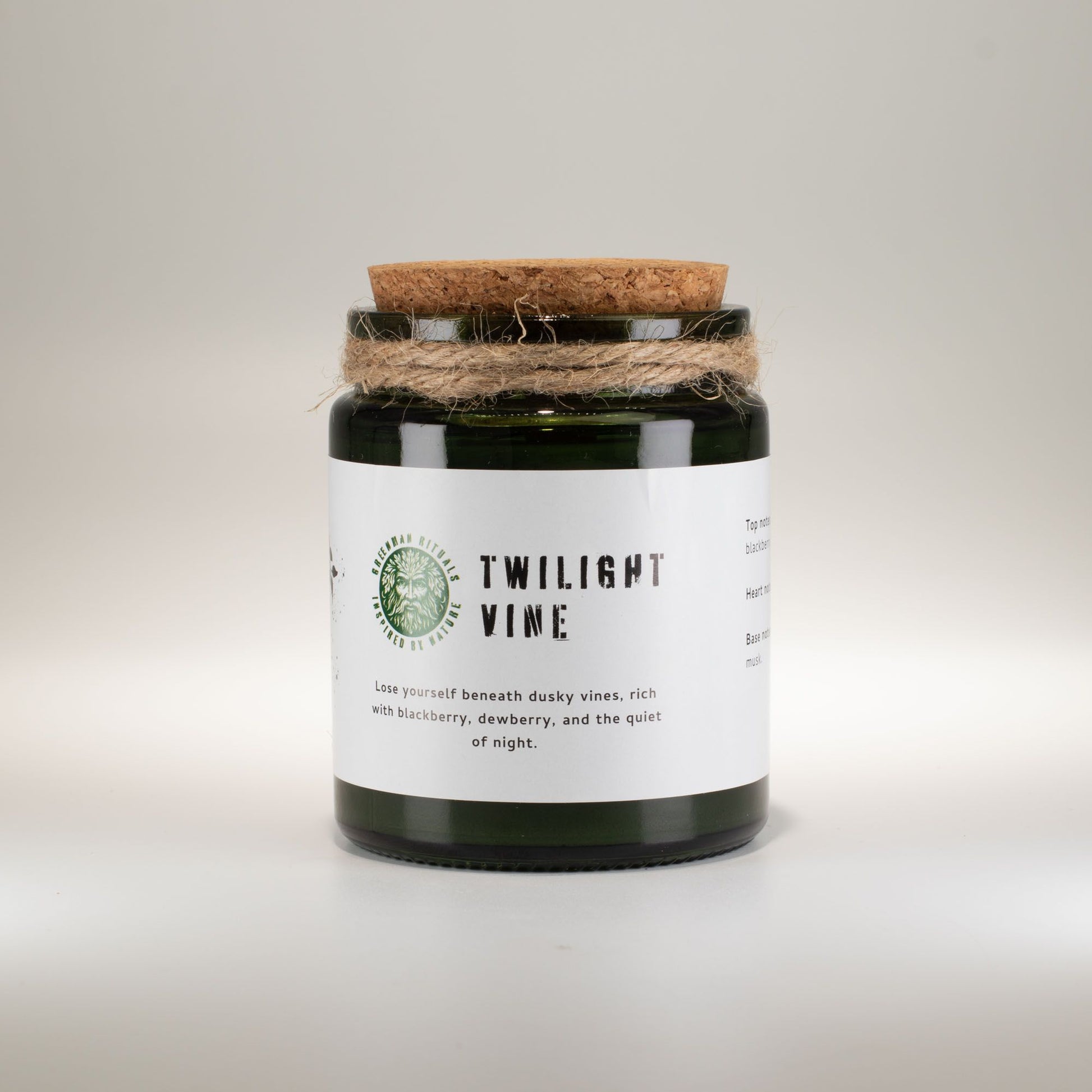 Vela de soja "Twilight Vine" en frasco verde, tapa de corcho, aroma a mora y durazno. Ideal para relajación.