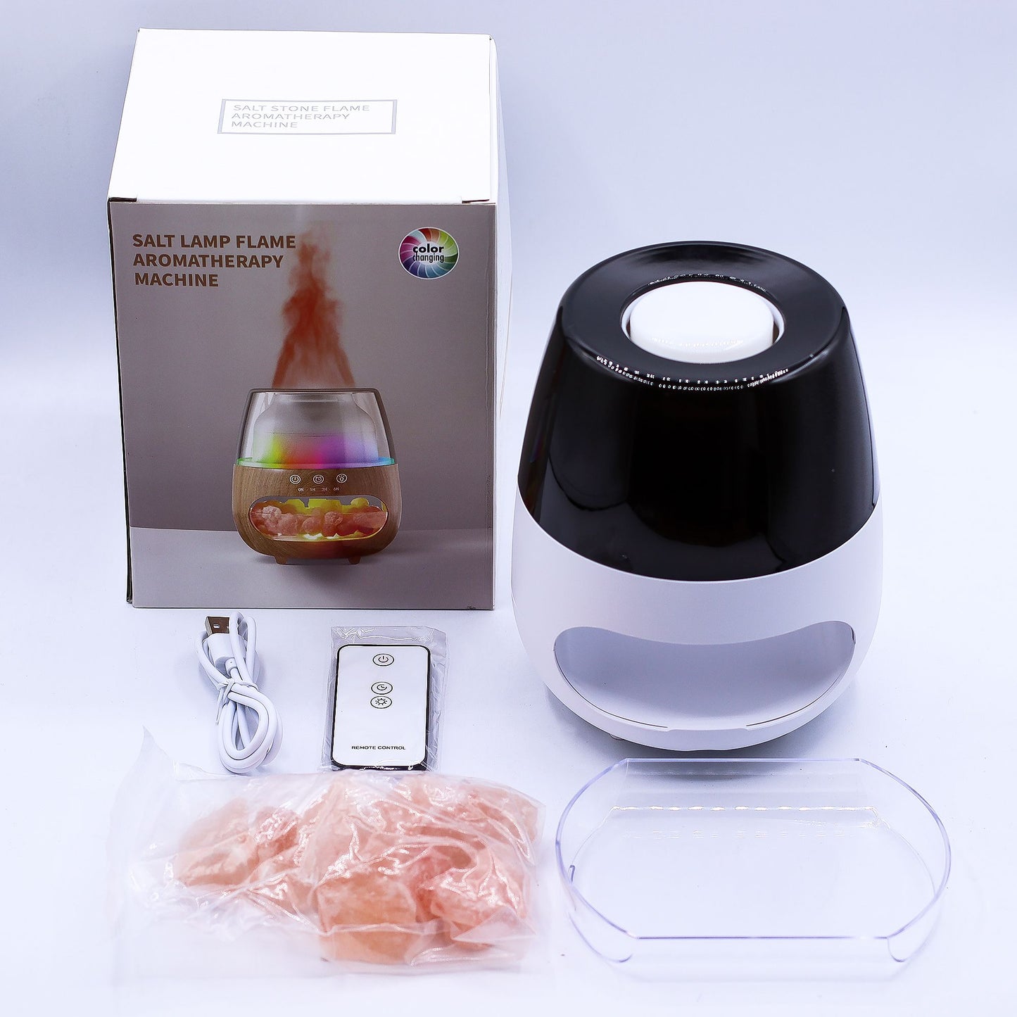 Difusor Ancient Wisdom blanco y negro, con sales, cable USB, control remoto y caja con imagen de efecto llama.