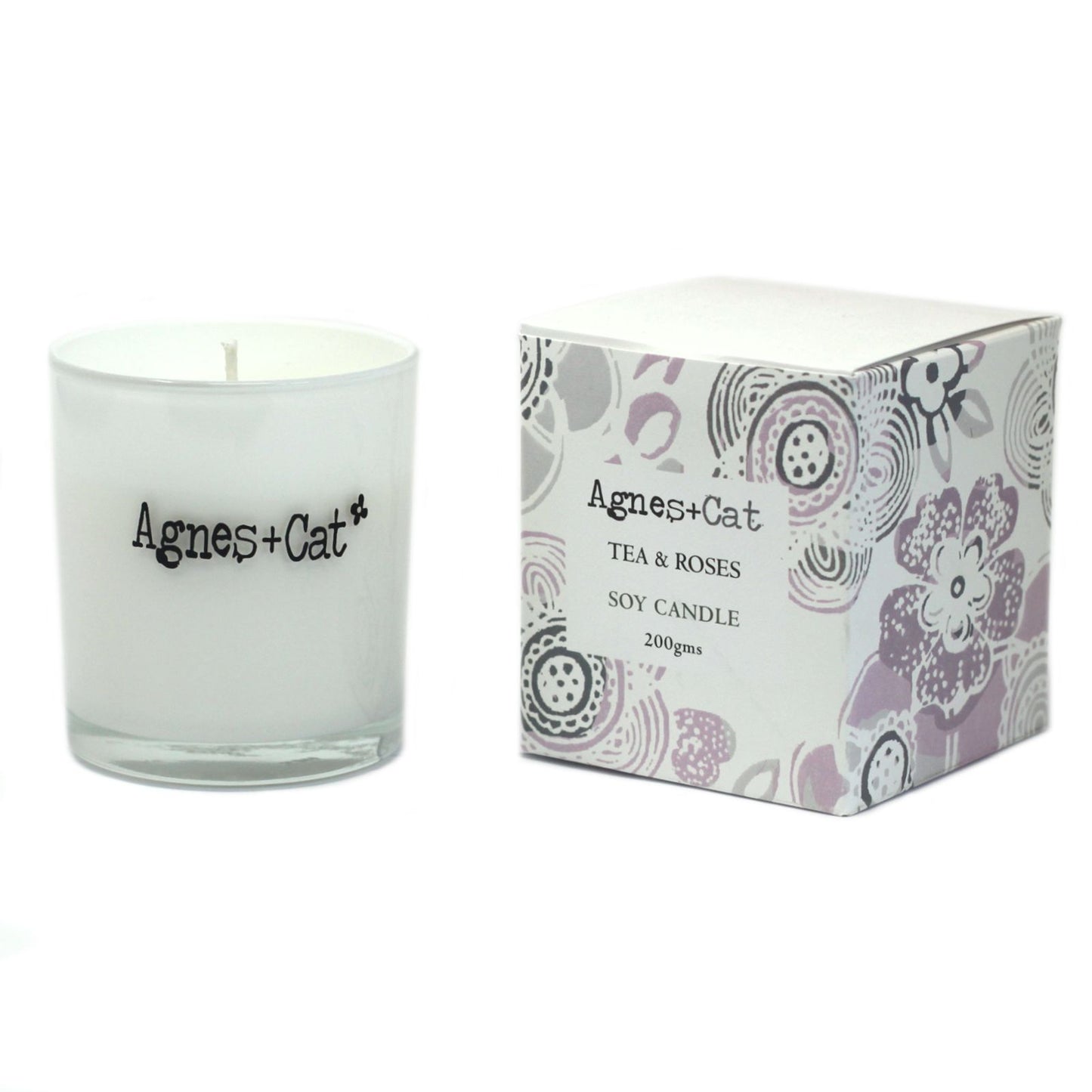Vela de soja blanca "Tea & Roses" de Agnes + Cat, envase de vidrio y caja decorativa con flores en tonos pastel.