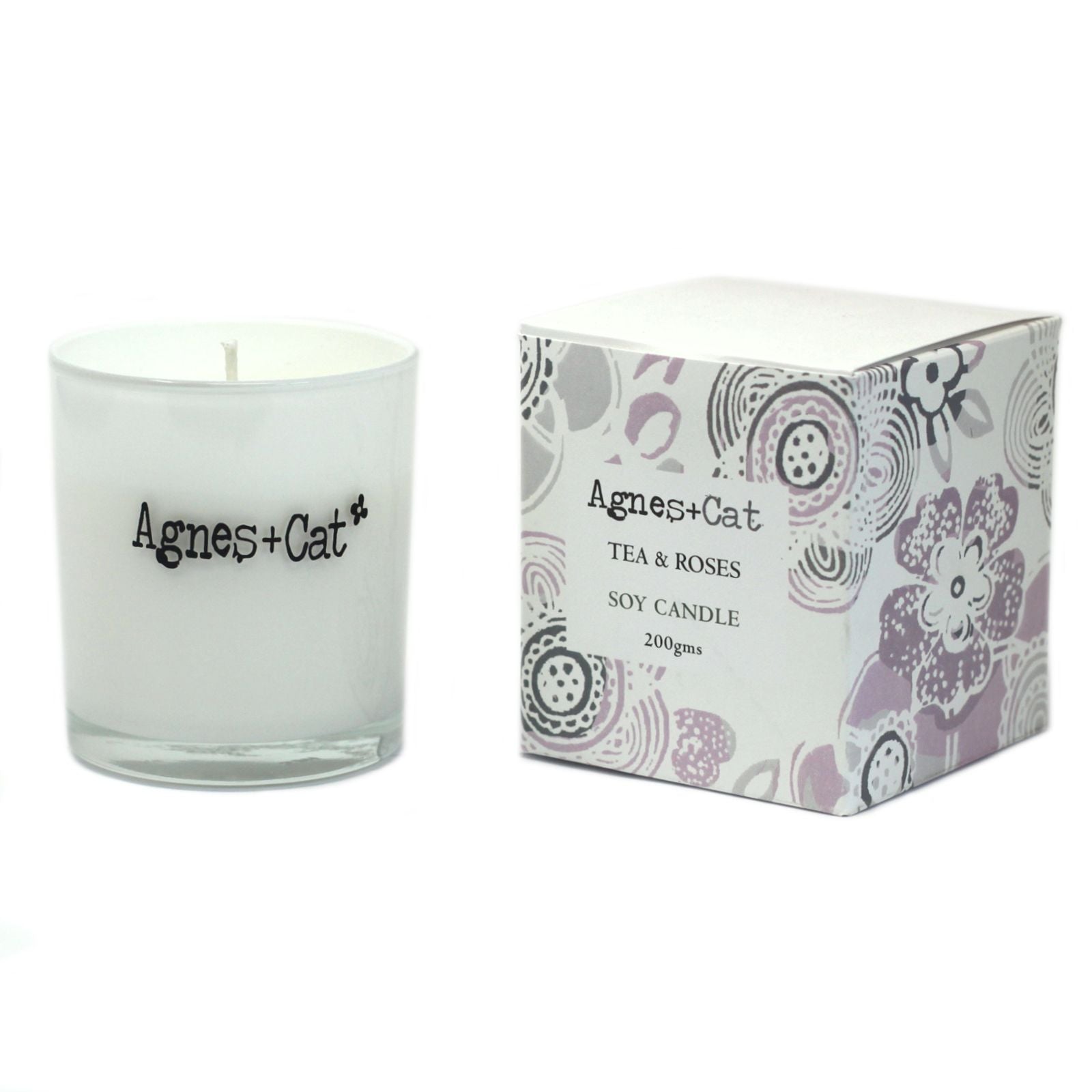 Vela de soja blanca "Tea & Roses" de Agnes + Cat, envase de vidrio y caja decorativa con flores en tonos pastel.