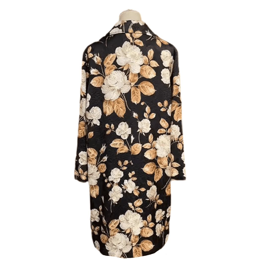 Back view of a long, black brocade overcoat featuring an intricate beige rose and leaf floral pattern.