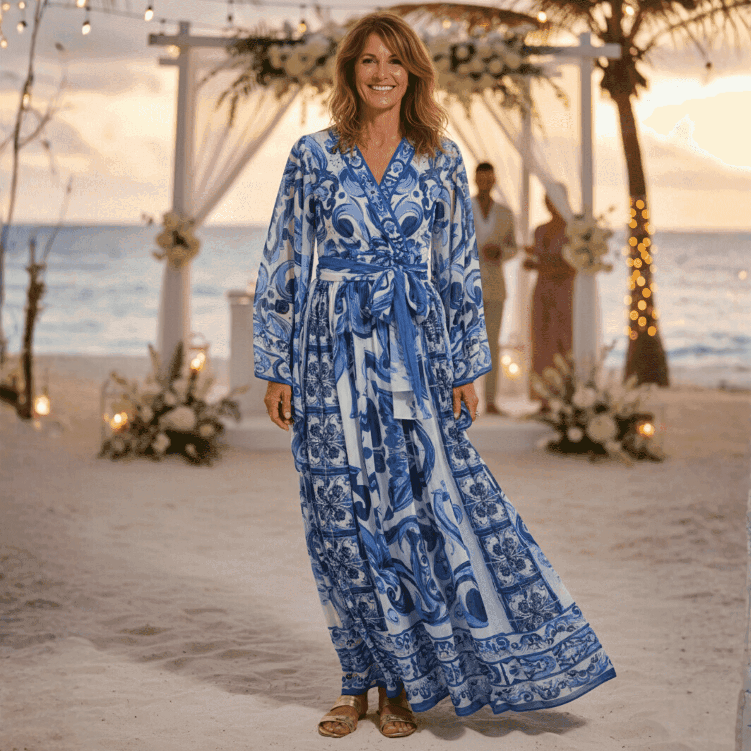 Blue and white patterned maxi dress with long sleeves and a tie waist, perfect for beach weddings or summer outings.