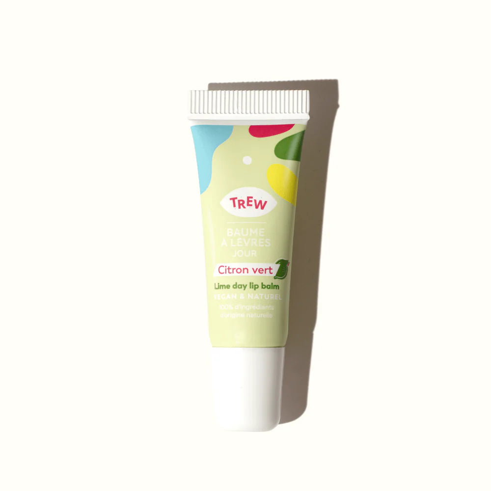 Lime day lip balm in a light green squeezable tube with colorful abstract shapes and Trew branding.