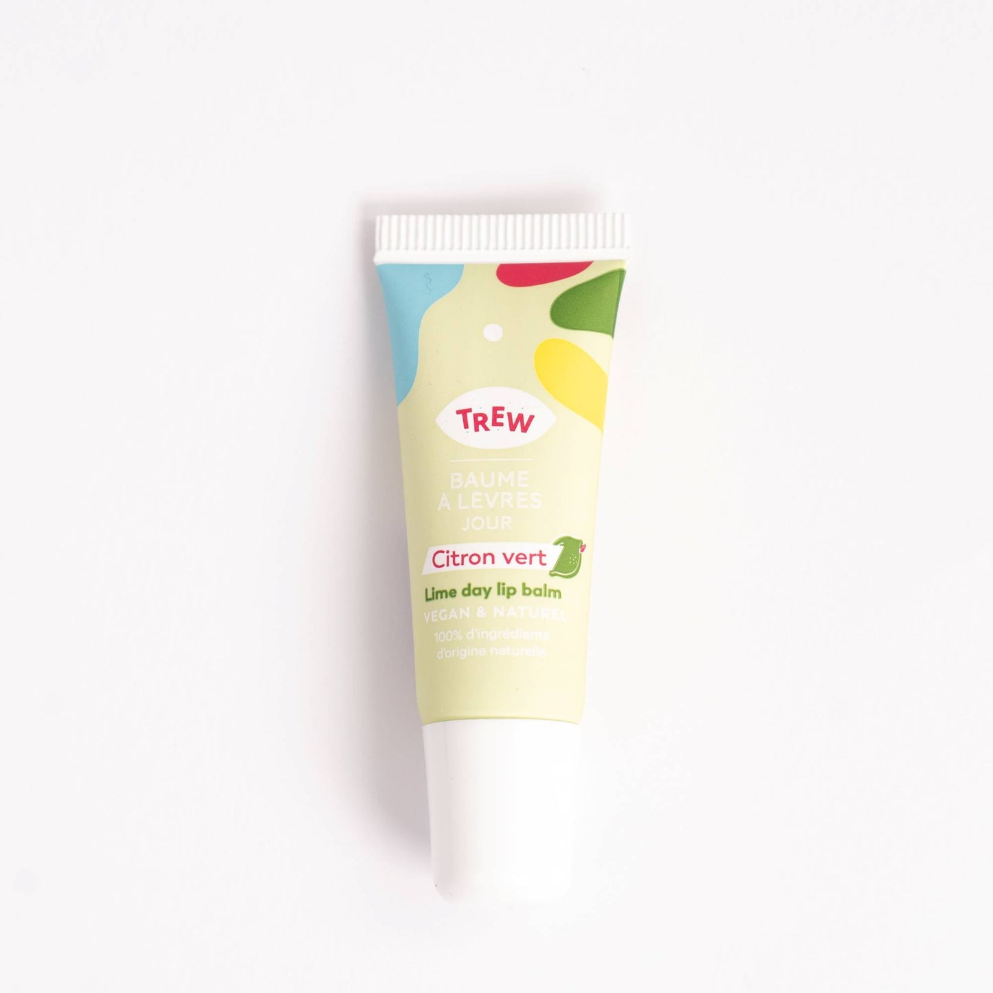 A squeeze tube of lime-scented lip balm with a cream-colored body, vibrant abstract shapes, and a white screw-on cap.