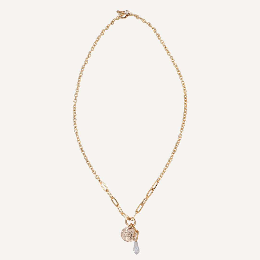 Collar dorado con eslabones, charm redondo y gota de cristal transparente. Estilo elegante y moderno.