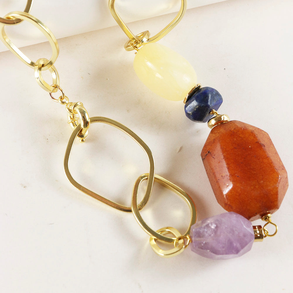 Pendientes de metal dorado con gemas coloridas: ámbar, sodalita, cuarzo rosa y amatista; estilo moderno y elegante.