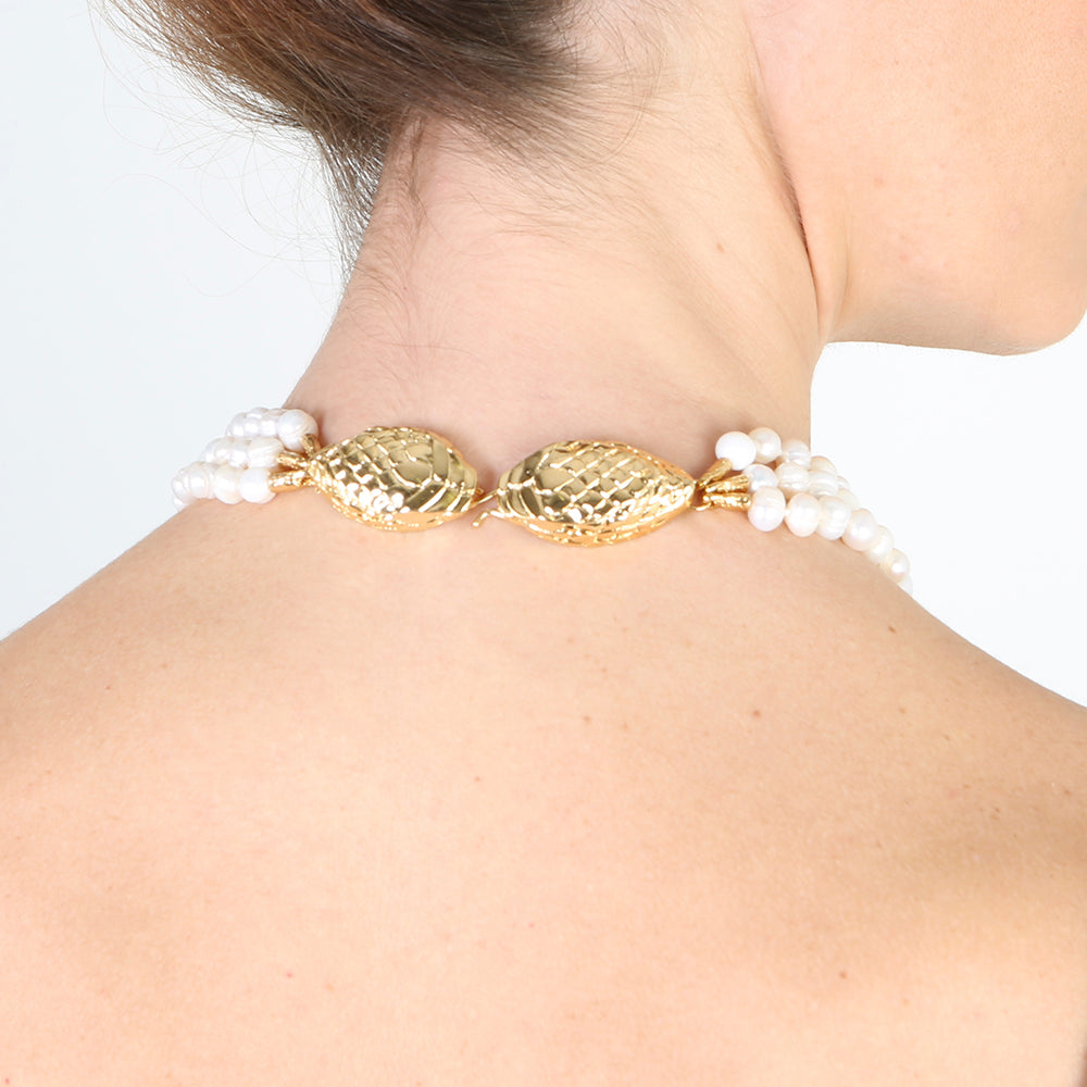 Collar elegante de perlas blancas con detalles dorados en forma de pez, ideal para ocasiones especiales.
