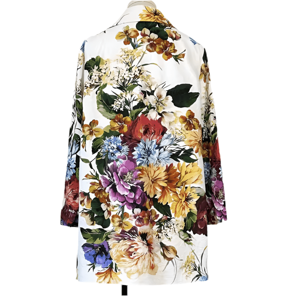White long jacket featuring a vibrant, multicolored floral print on textured brocade fabric with a notched collar.
