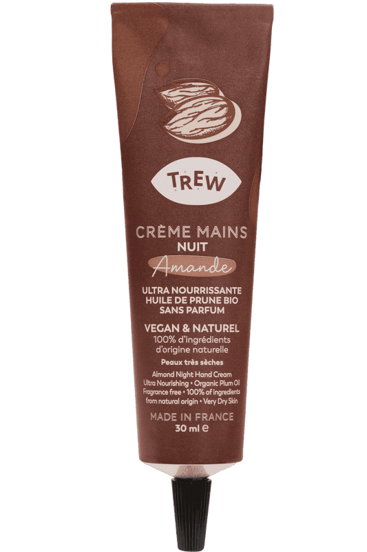 A brown squeeze tube of almond night hand cream by Trew, featuring text details on an almond-shaped label.