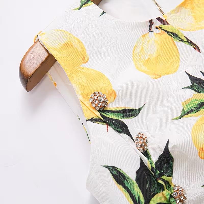 White floral dress with yellow lemon print and jewel button details, perfect for summer outings.