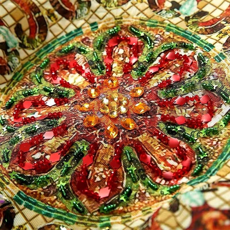 Vibrant red and green sequin floral embroidery on gold fabric, perfect for festive occasions and stylish outfits.
