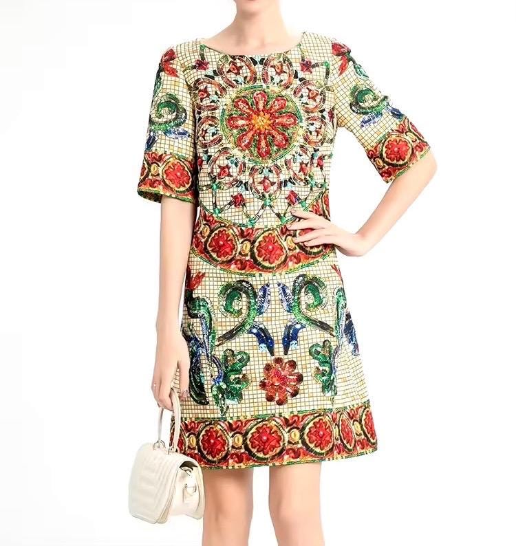 Colorful embroidered short-sleeve dress with intricate floral patterns, featuring red, green, and blue details.