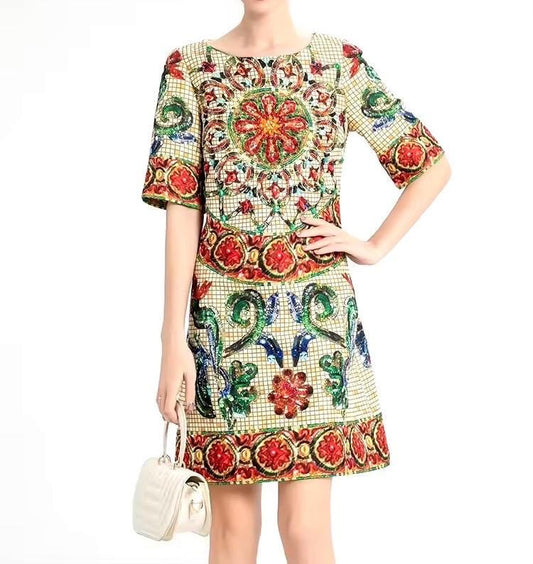 Colorful embroidered short-sleeve dress with intricate floral patterns, featuring red, green, and blue details.