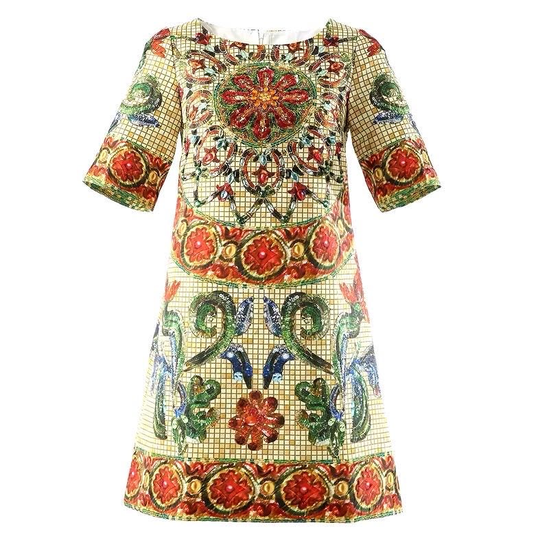 Colorful printed shift dress with short sleeves, featuring intricate floral patterns in red, green, and blue on a cream background.