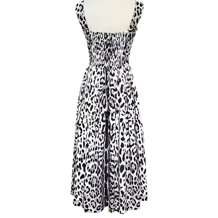 Black and white leopard print sundress with smocked bodice and flowy skirt, perfect for summer outings.