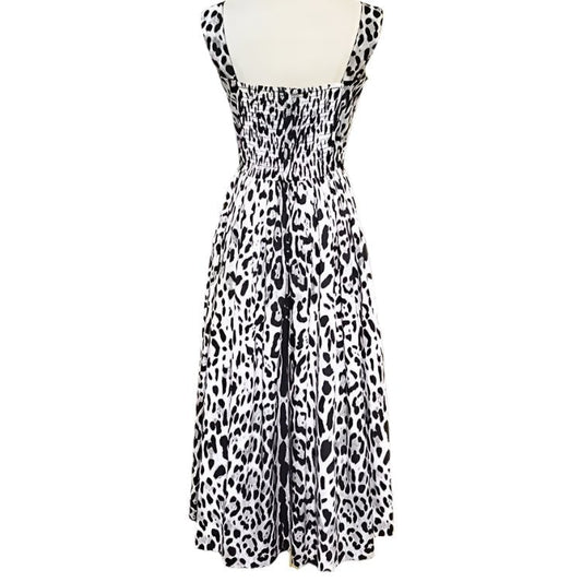Black and white leopard print sundress with smocked bodice and flowy skirt, perfect for summer outings.