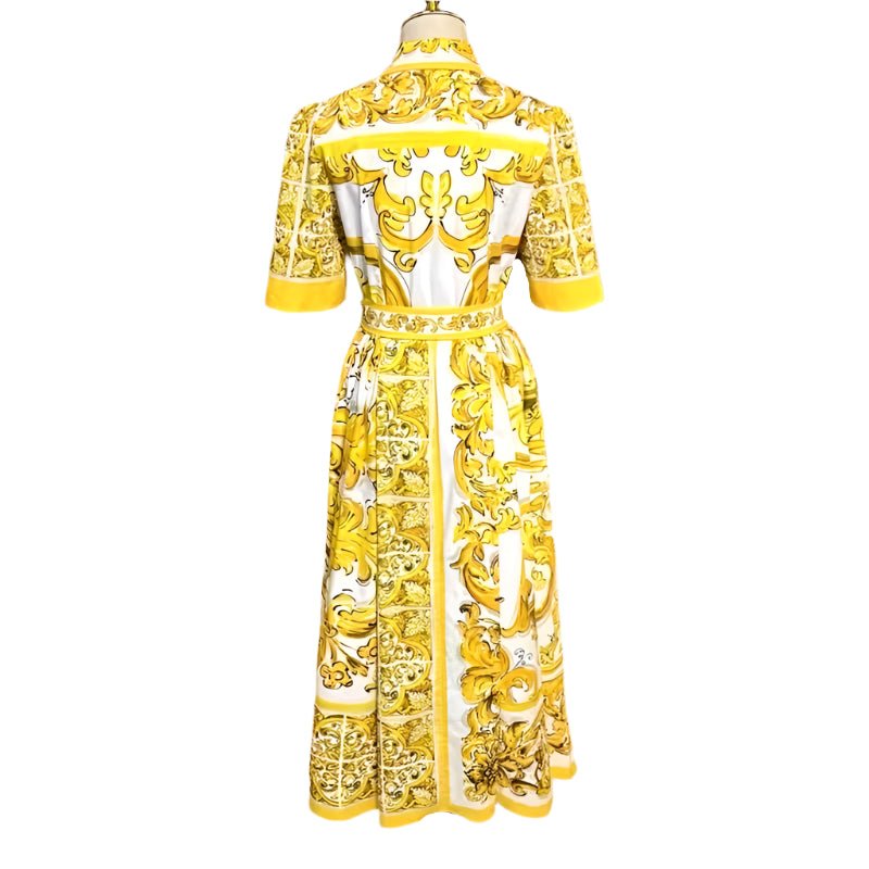 Yellow and white floral print midi dress with short sleeves and a tie belt, featuring elegant baroque-style patterns.