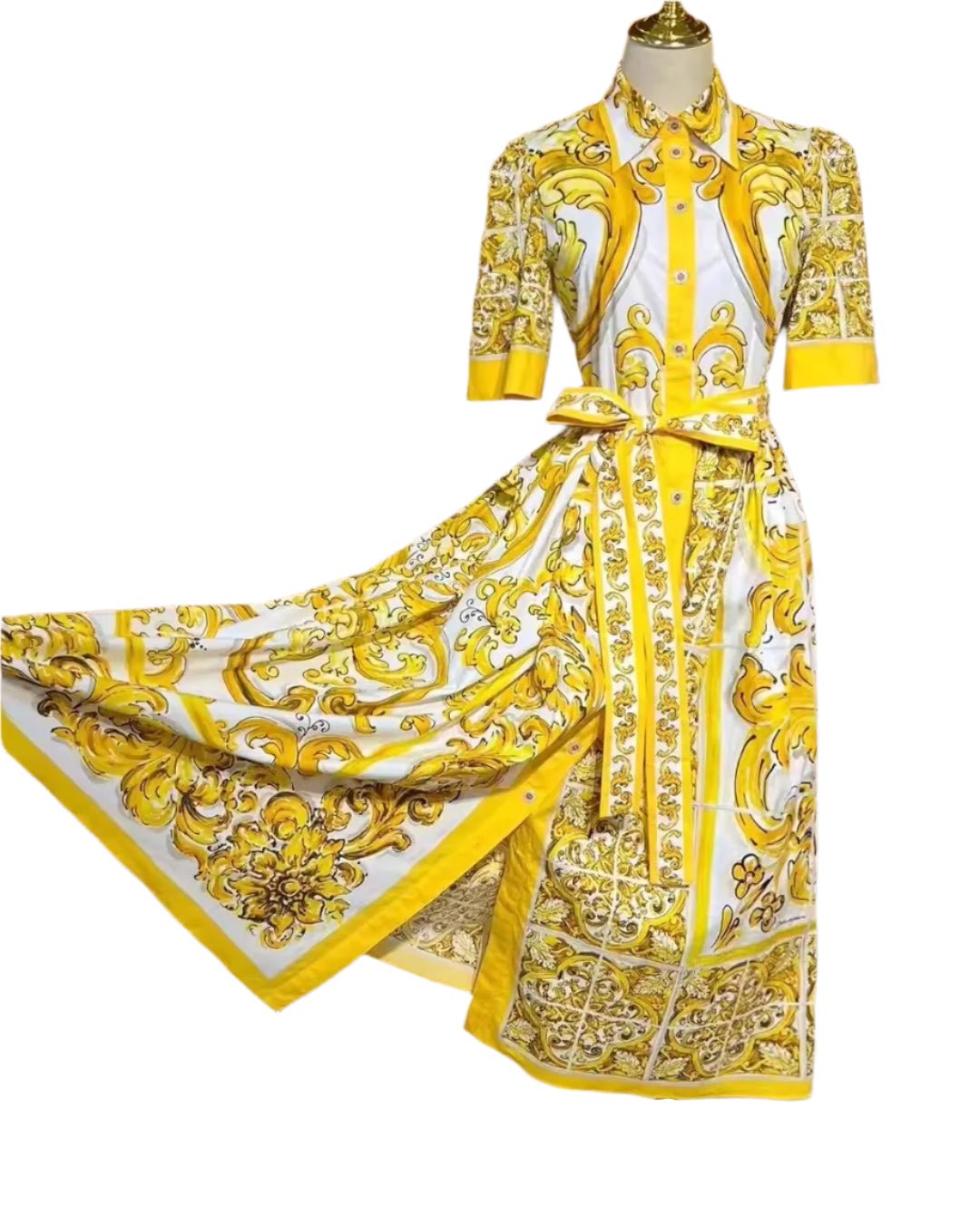 Yellow and white floral patterned maxi dress with short sleeves and a tie waist, made from lightweight fabric.